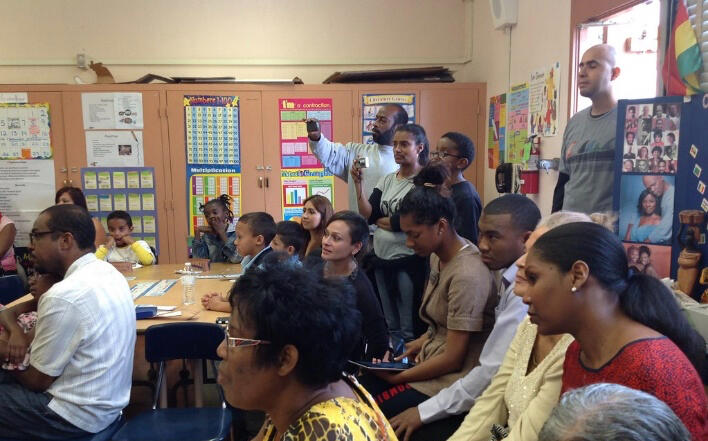 Proactive parents A school classroom filled with parents from mixed backgrounds.